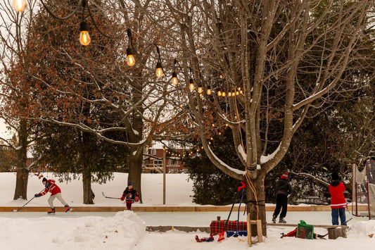 Outdoor hockey rink on frozen pond with players skating